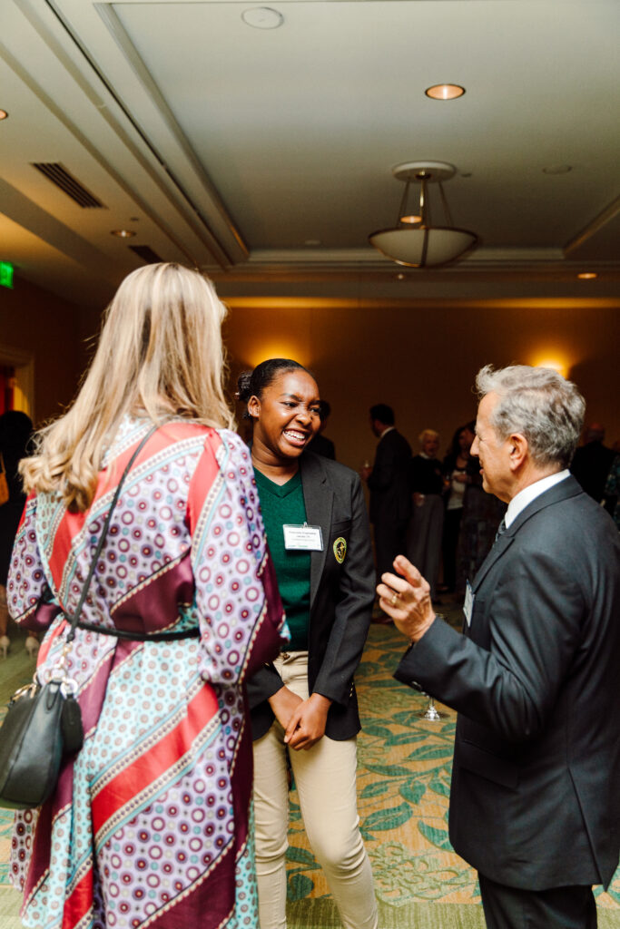 Cathedral Scholar talking to the guests at the AASF Gala